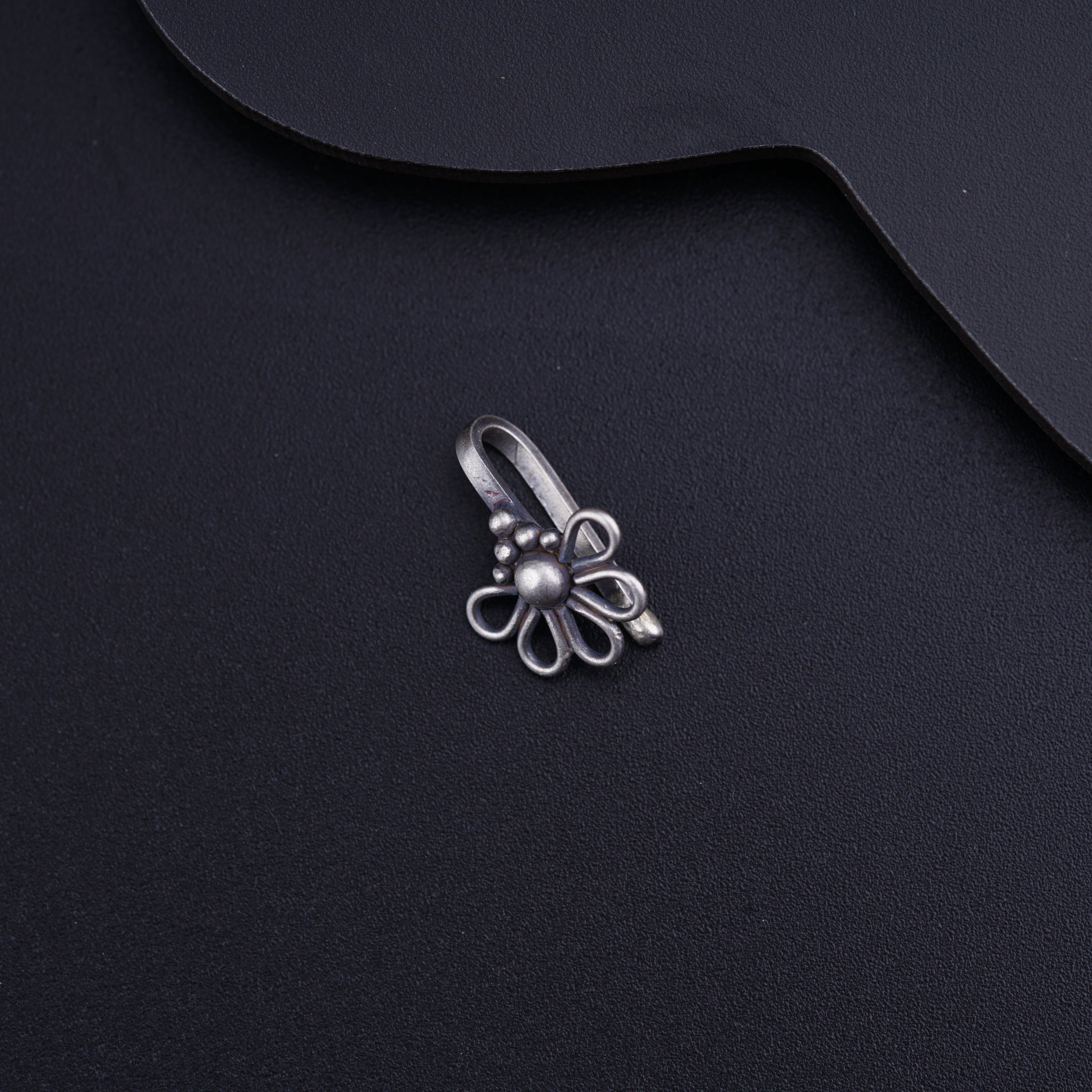 a metal object on a black surface
