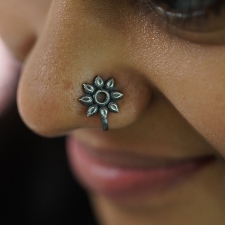 a close up of a person with a nose piercing