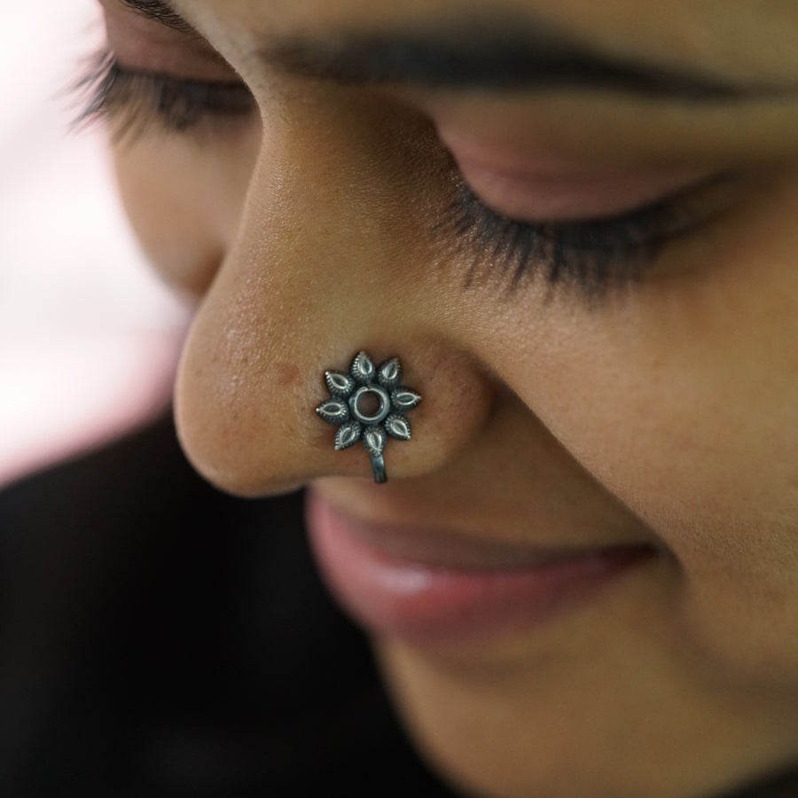 a close up of a person with a nose piercing