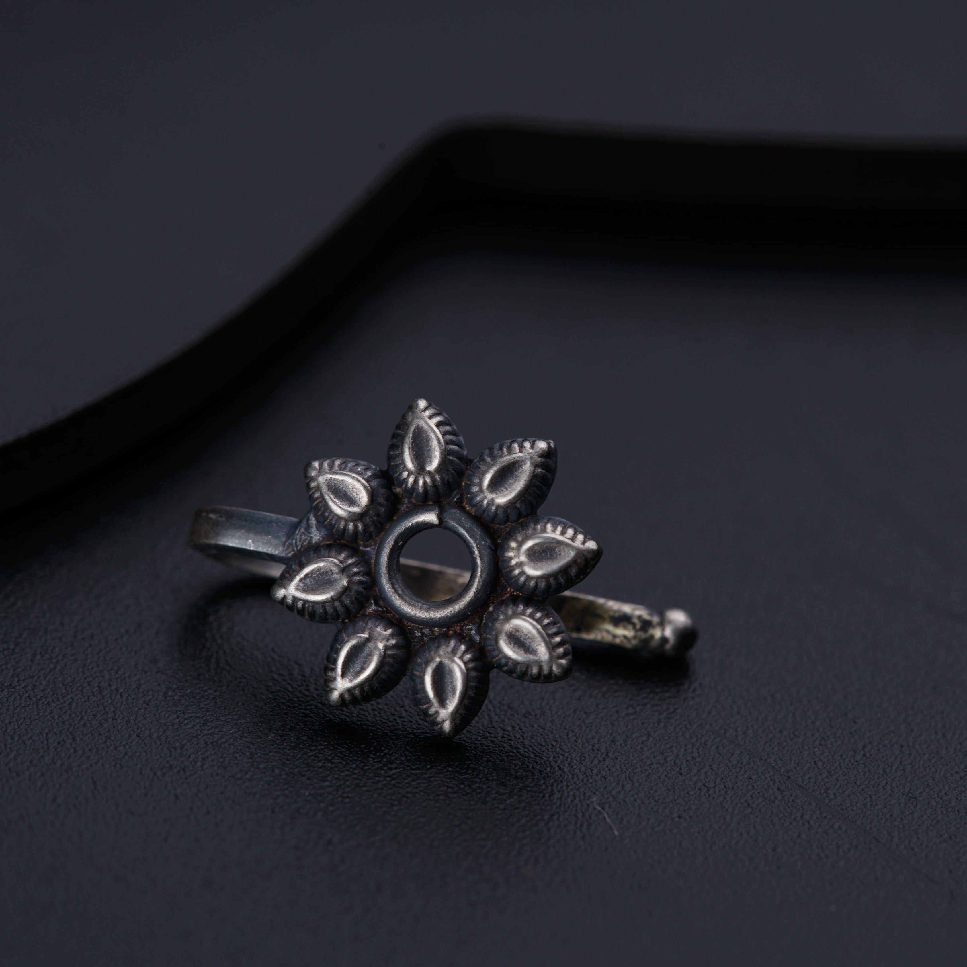 a close up of a ring on a black surface