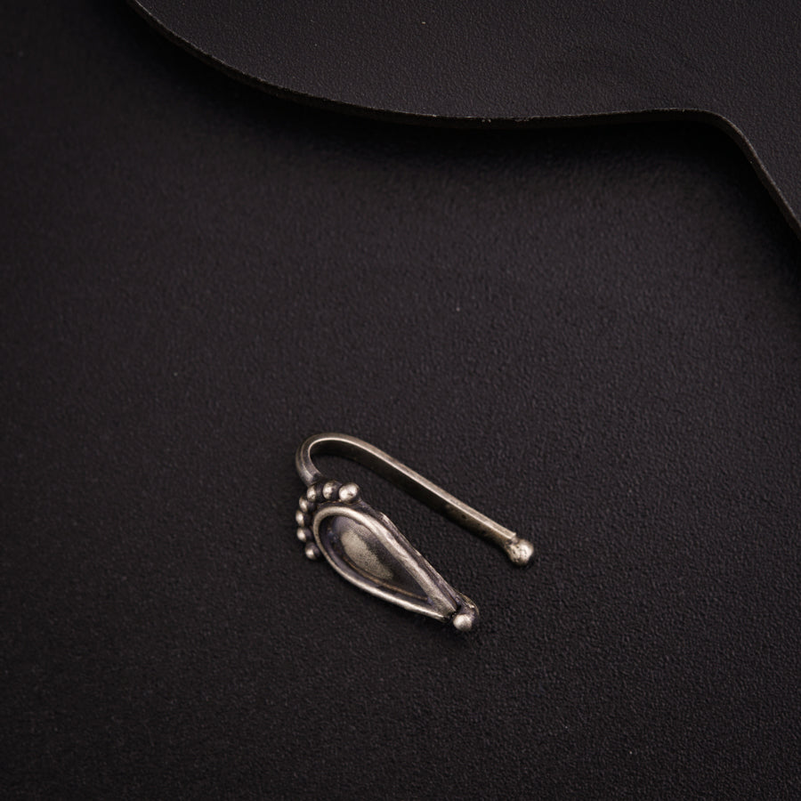 a pair of scissors sitting on top of a black cloth