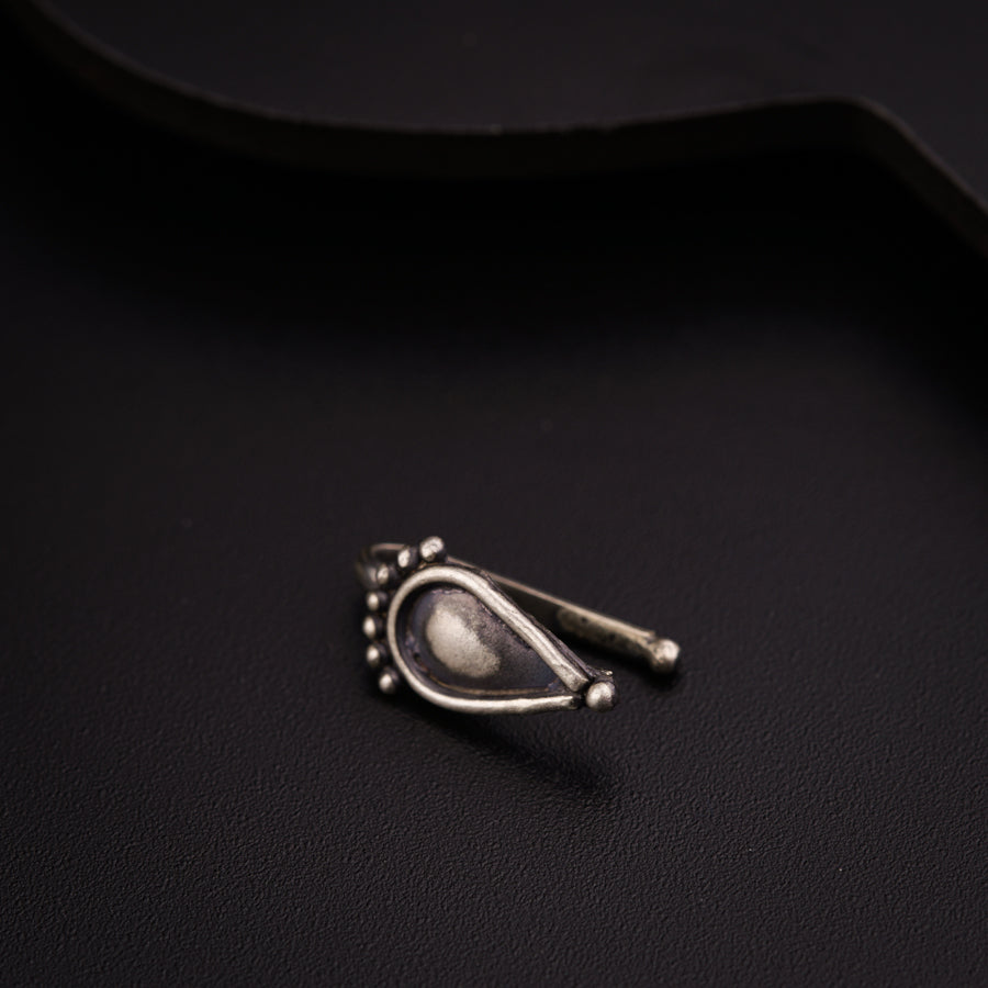a close up of a metal object on a black surface