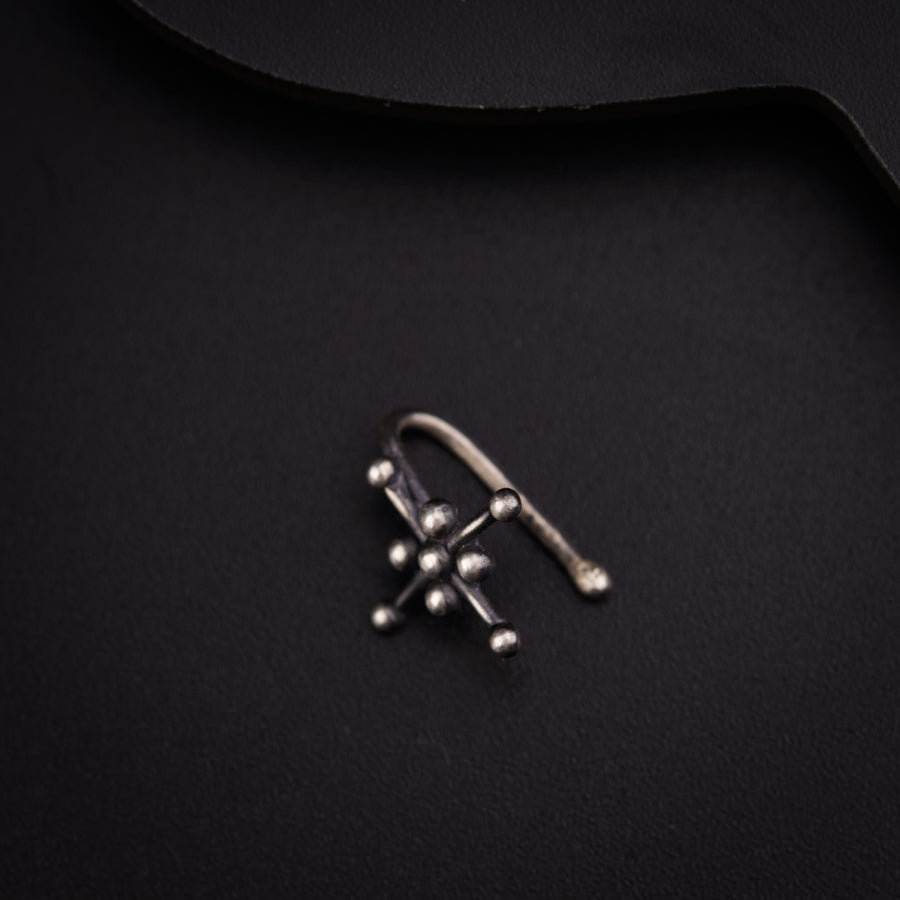 a close up of a metal object on a black surface