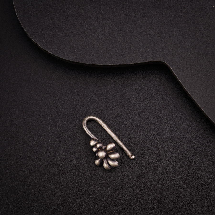 a close up of a pair of earrings on a black surface