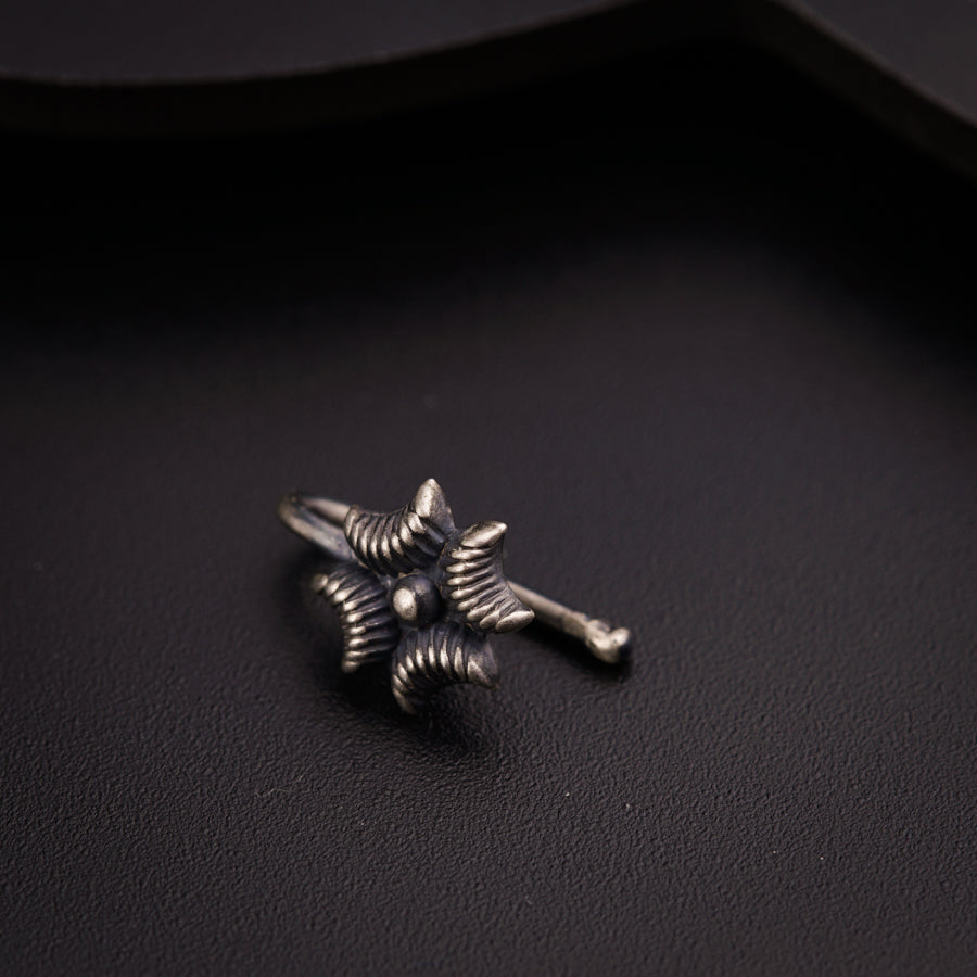 a close up of a metal object on a black surface