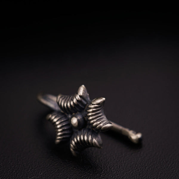 a close up of a metal object on a black surface