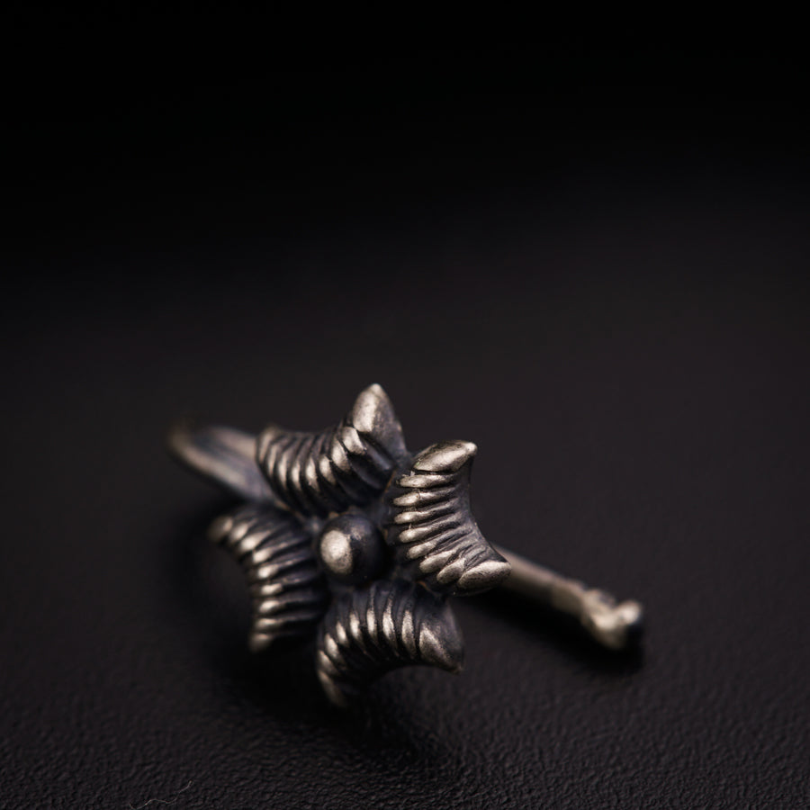 a close up of a metal object on a black surface