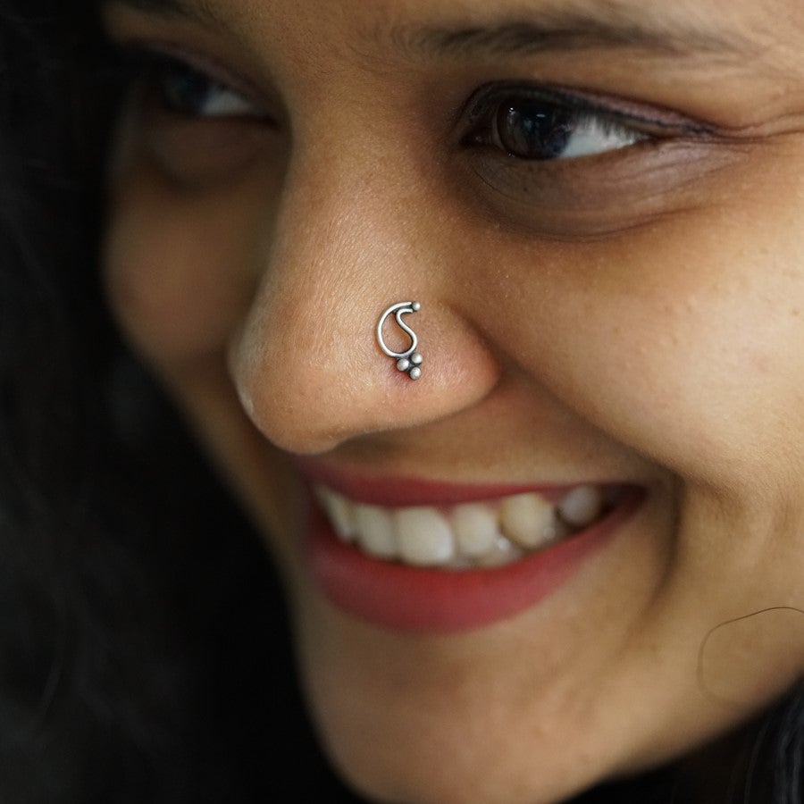 a close up of a woman with a nose piercing