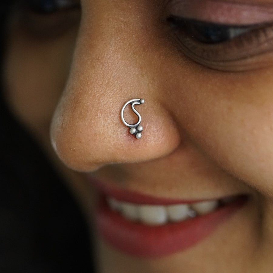 a close up of a person with a nose piercing