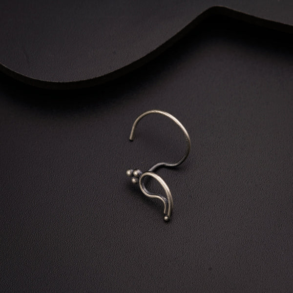 a close up of a pair of earrings on a black surface