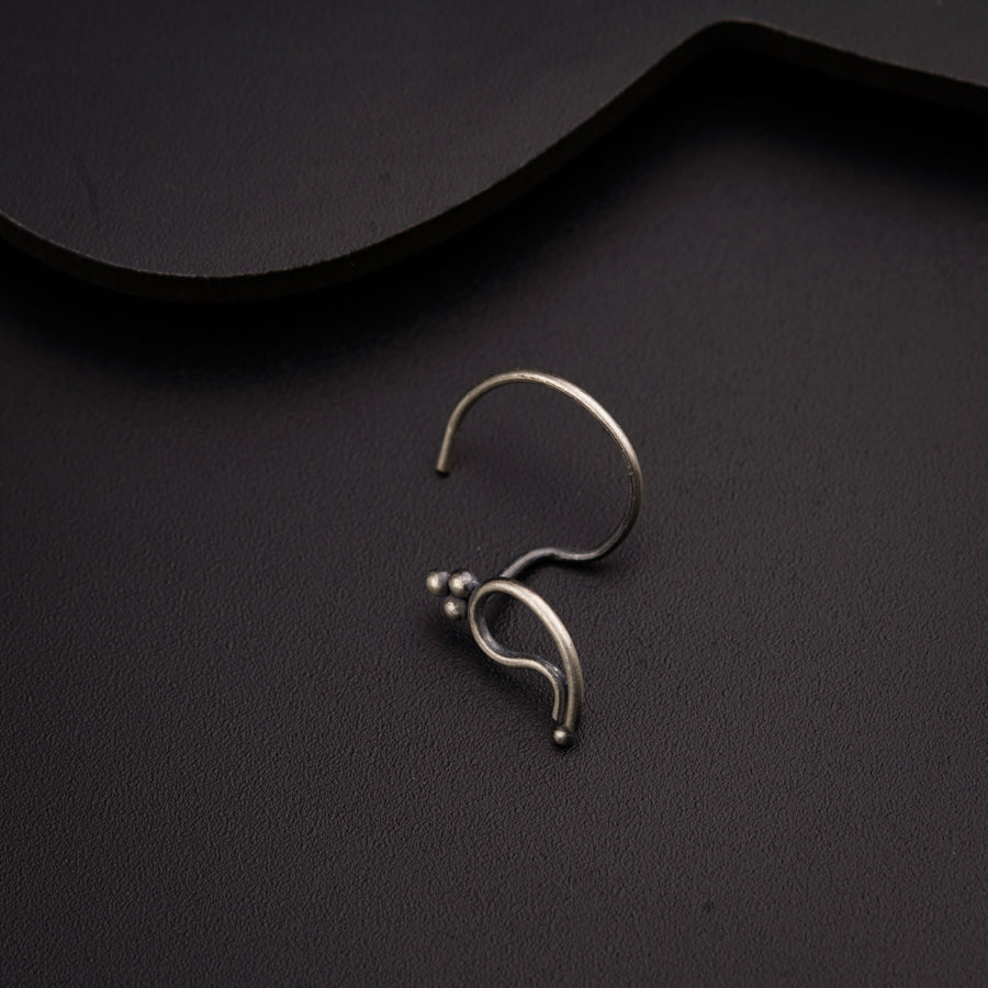 a close up of a pair of earrings on a black surface