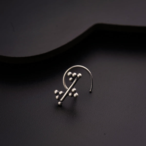 a pair of earrings sitting on top of a black surface