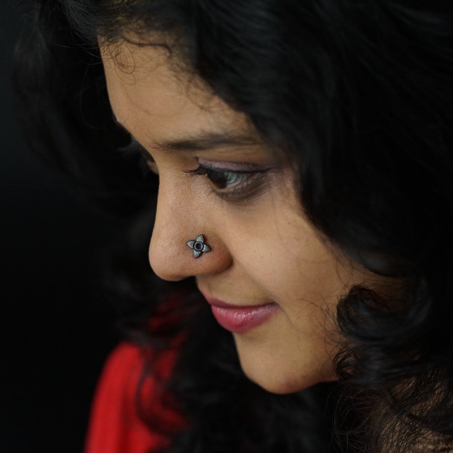 a close up of a woman with a nose piercing