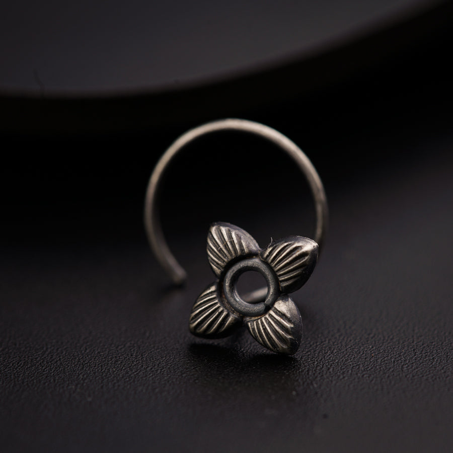 a silver ring with a flower on it