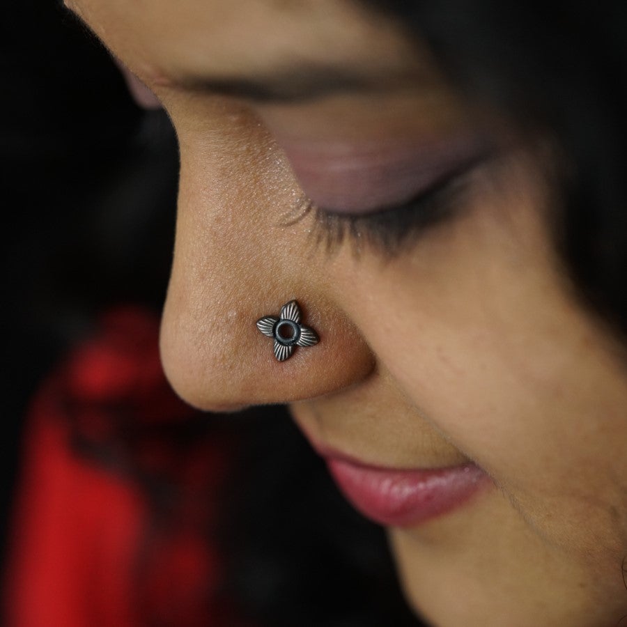a close up of a person with a nose piercing