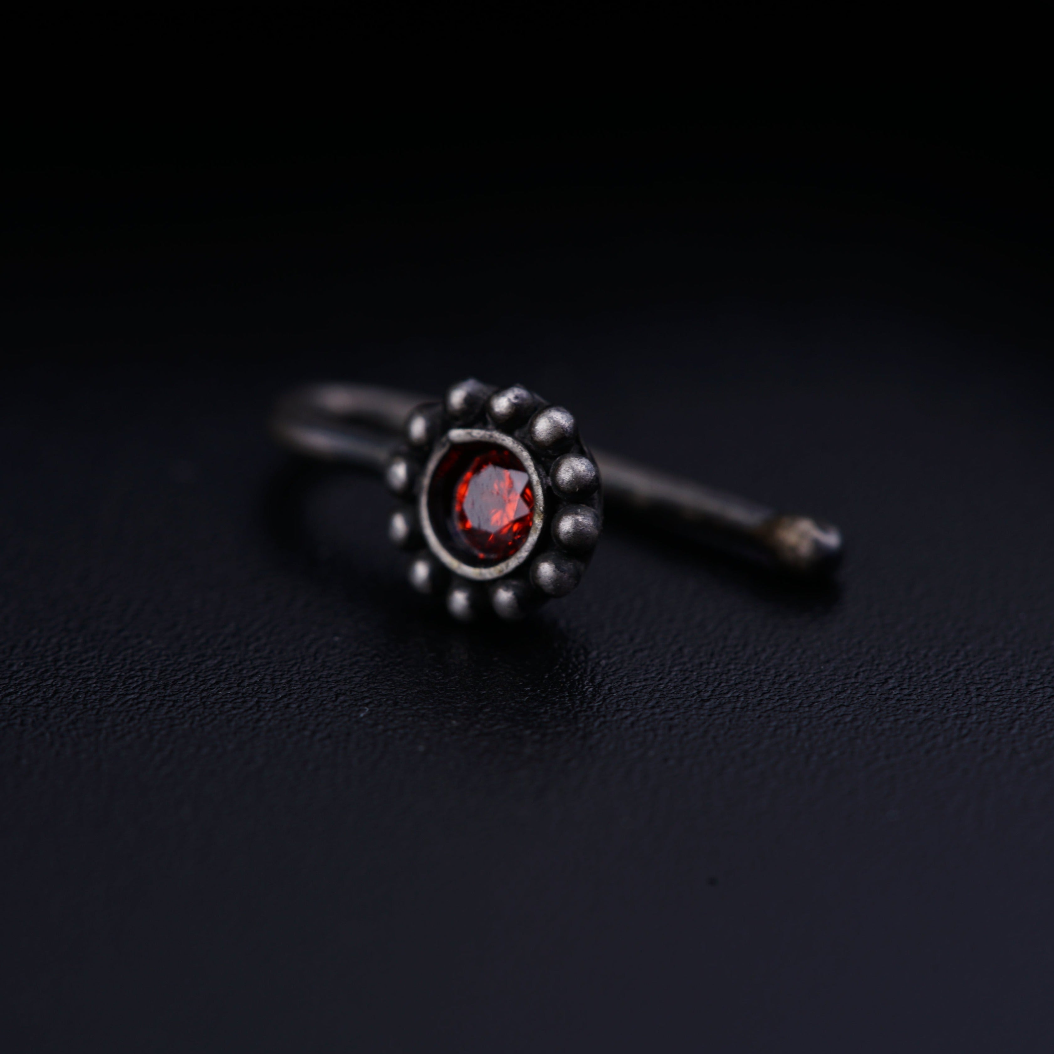 a close up of a ring on a black surface