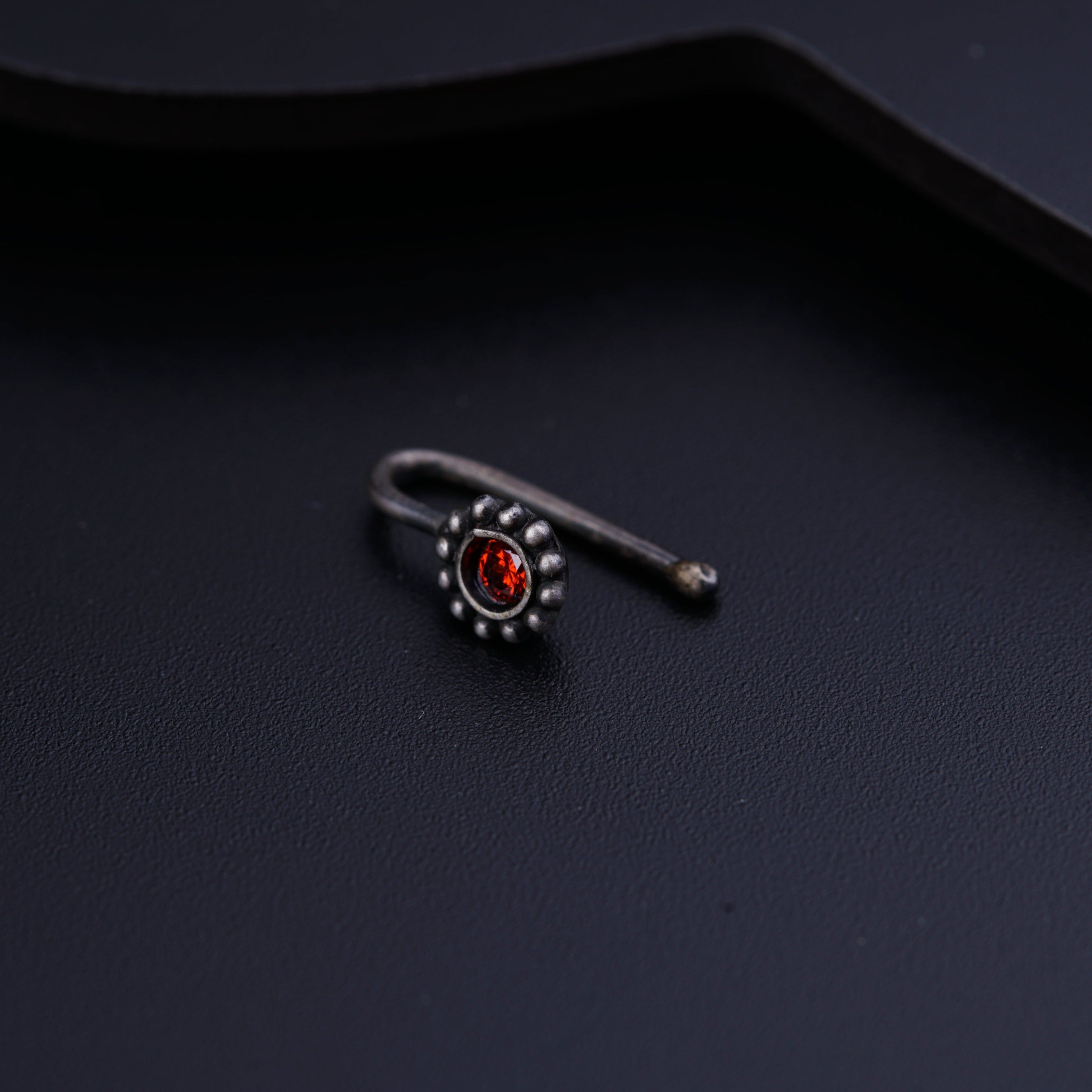 a close up of a ring on a black surface