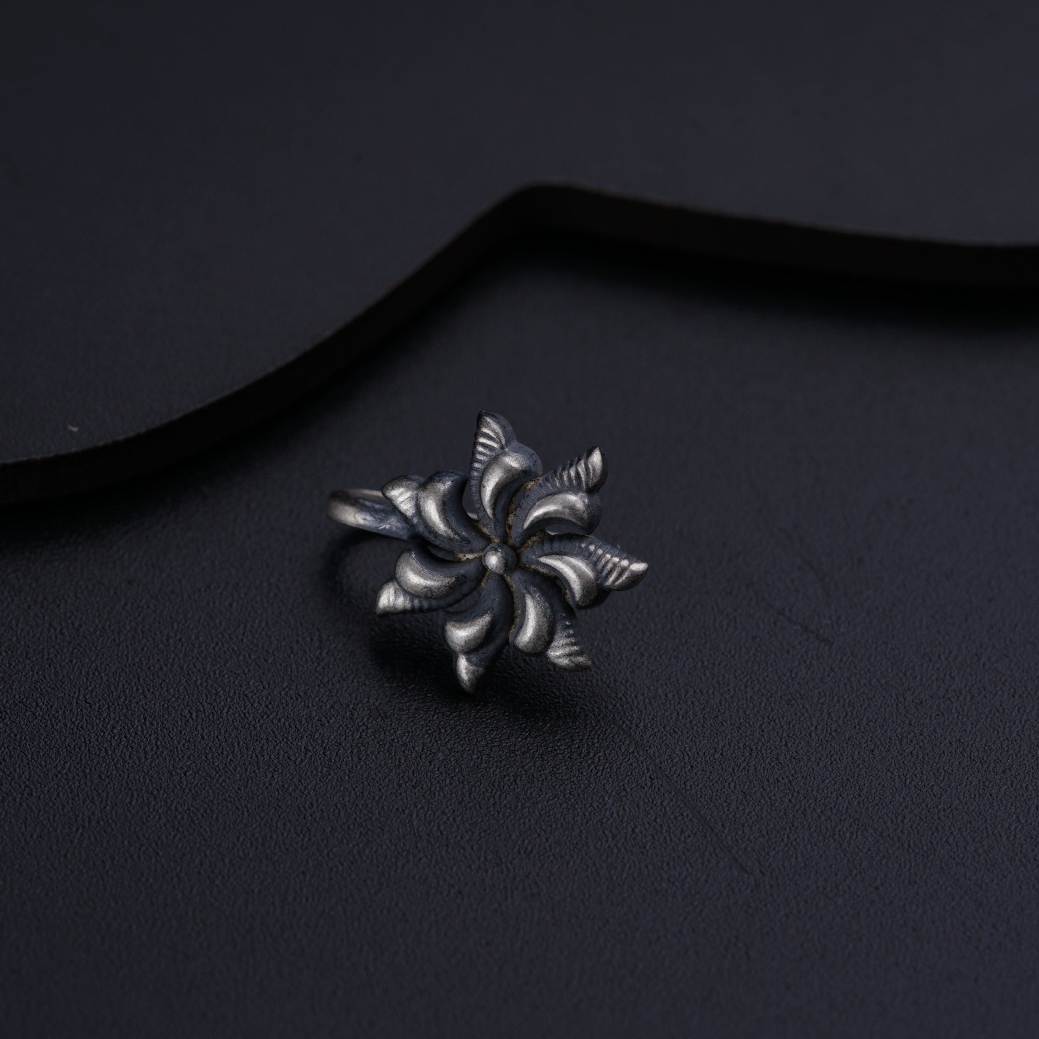 a close up of a metal object on a black surface