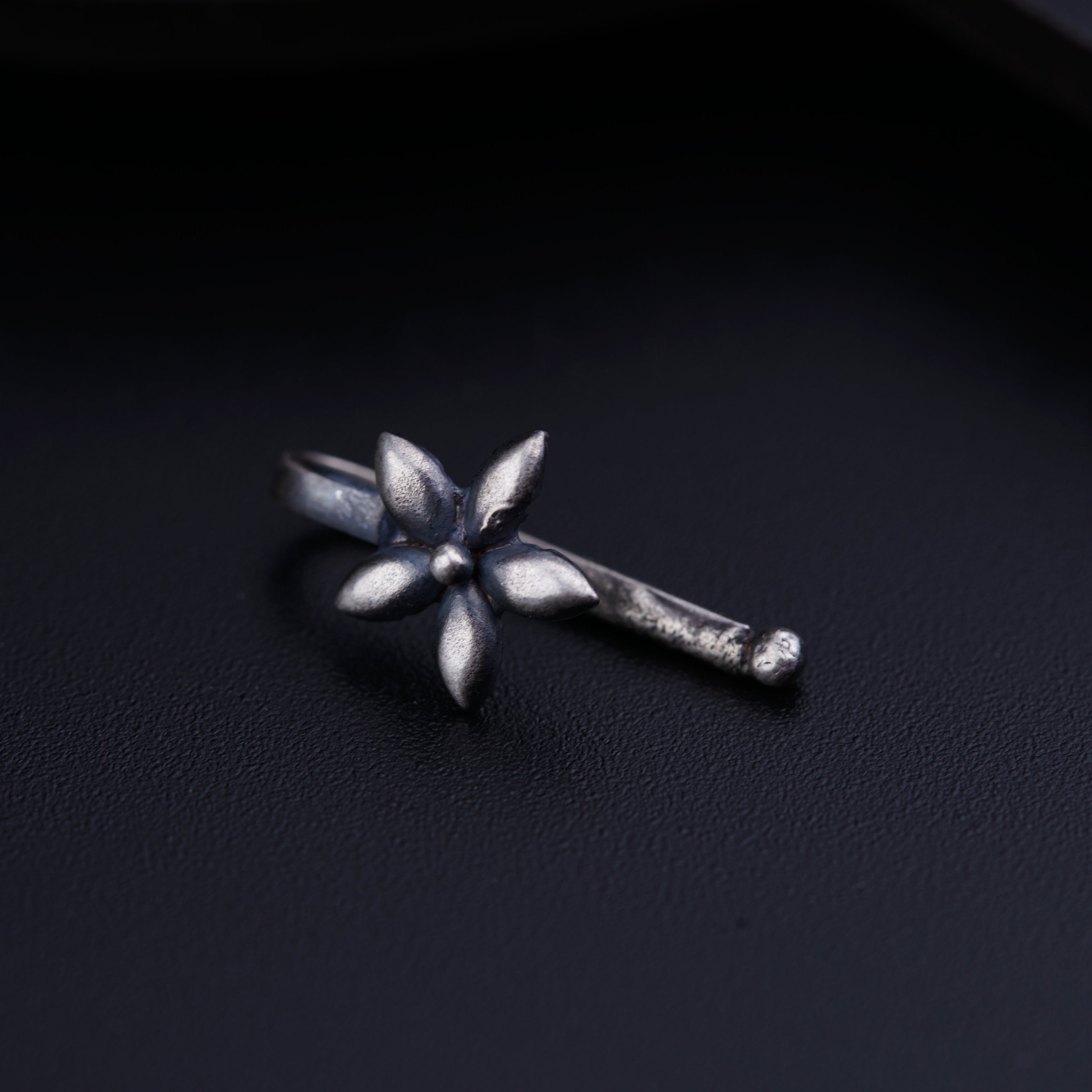 a close up of a metal object on a black surface