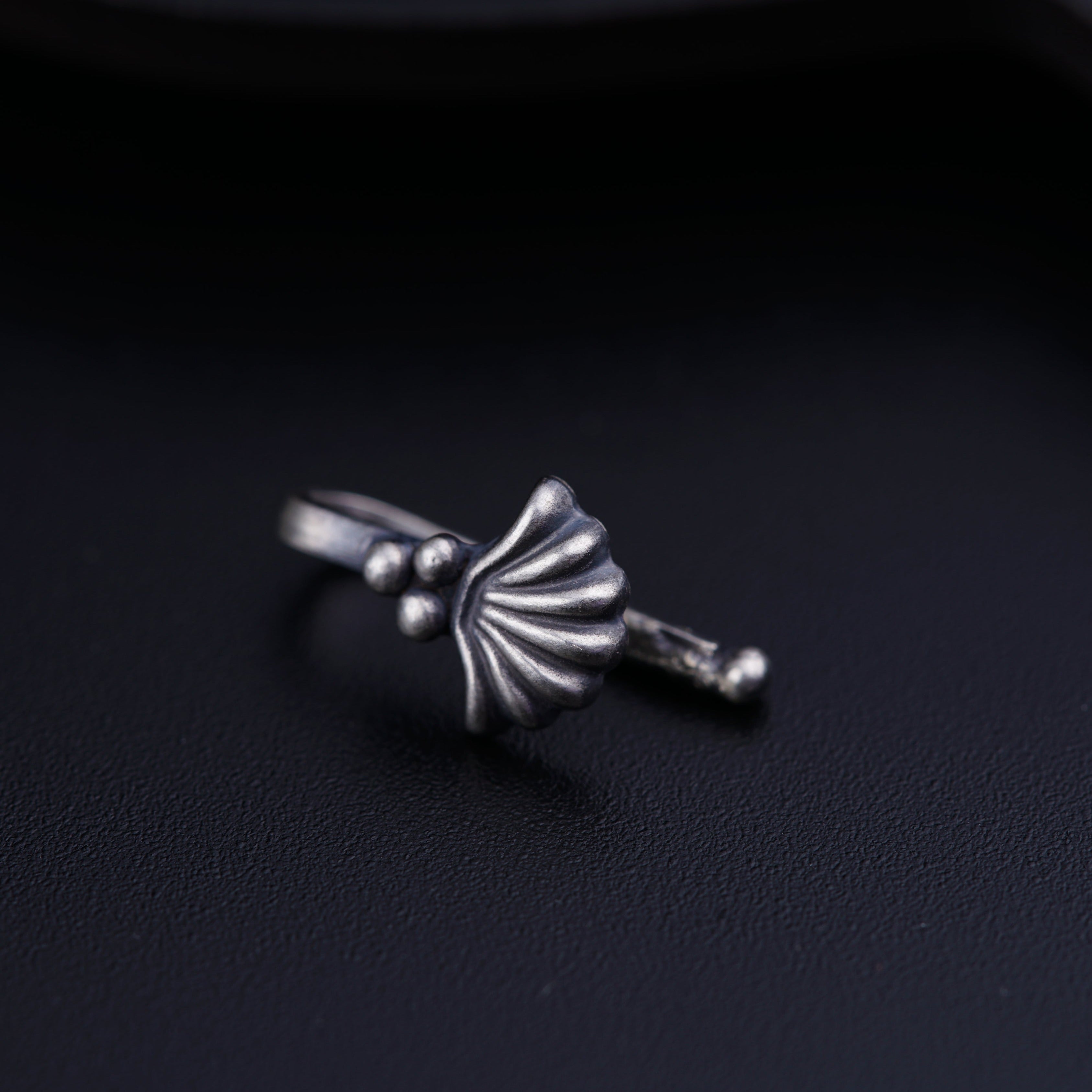 a close up of a ring on a black surface