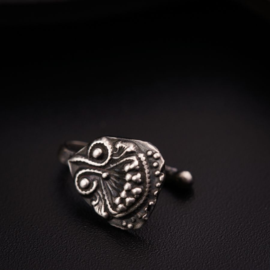 a close up of a ring on a black surface