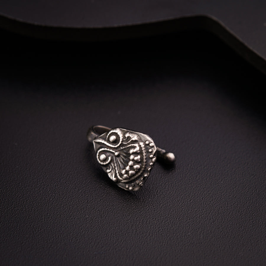 a close up of a ring on a black surface