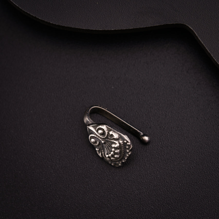 a close up of a metal object on a black surface