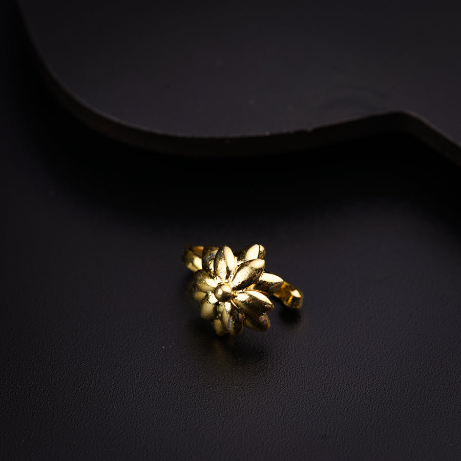 a close up of a pair of earrings on a black surface