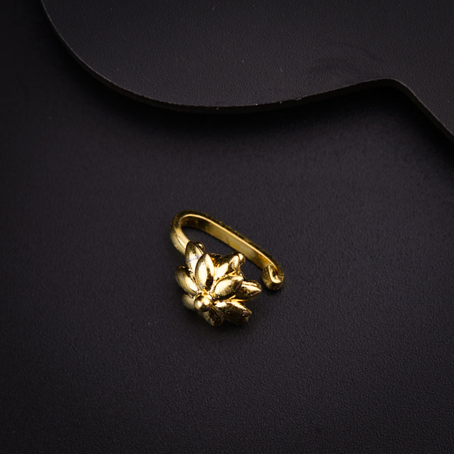 a gold ring sitting on top of a black surface