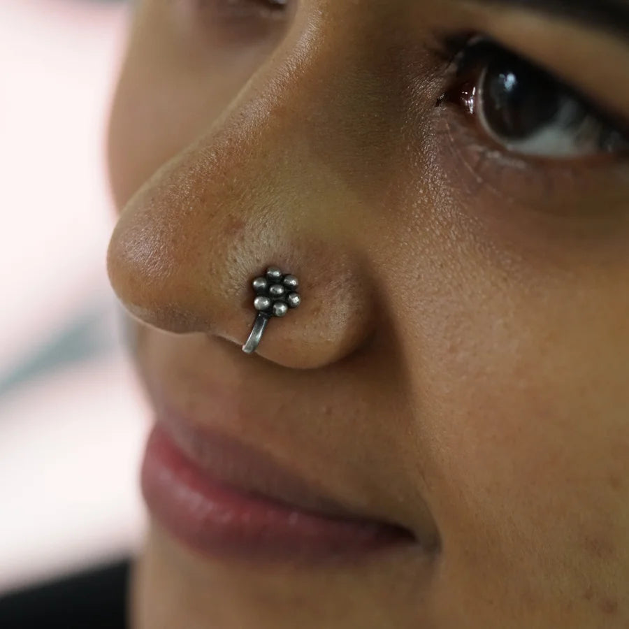 a close up of a person with a nose piercing