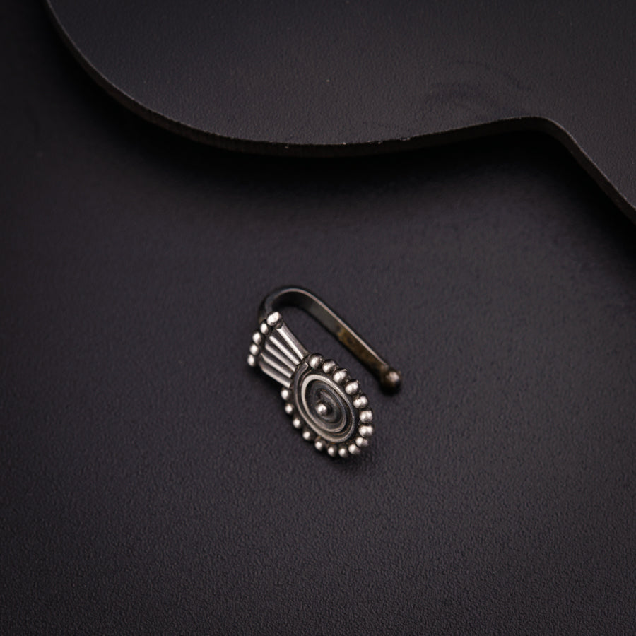 a black guitar with a metal clip on top of it