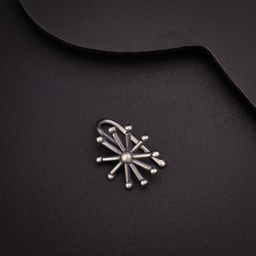 a metal object on a black surface