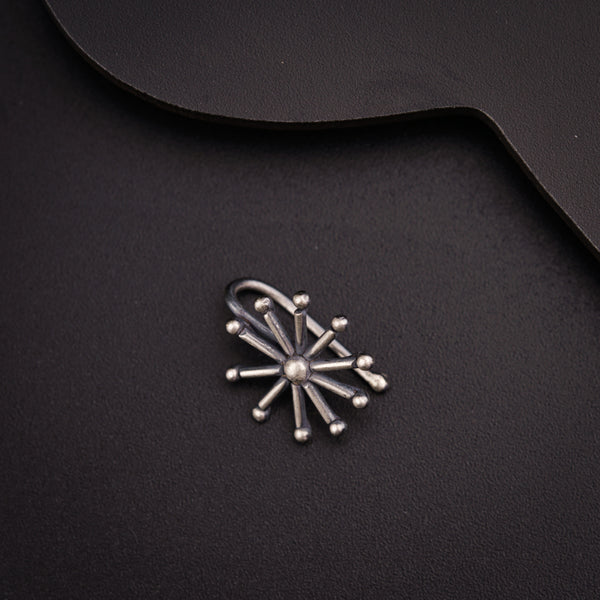a metal object on a black surface