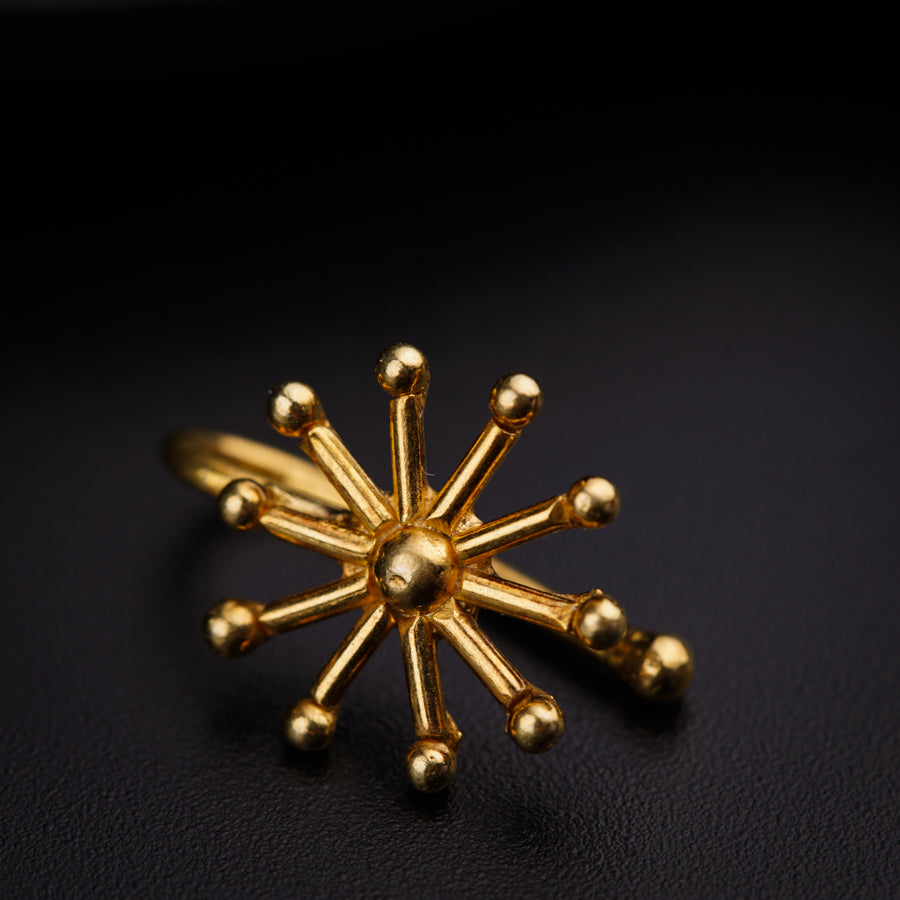 a close up of a gold ring on a black surface