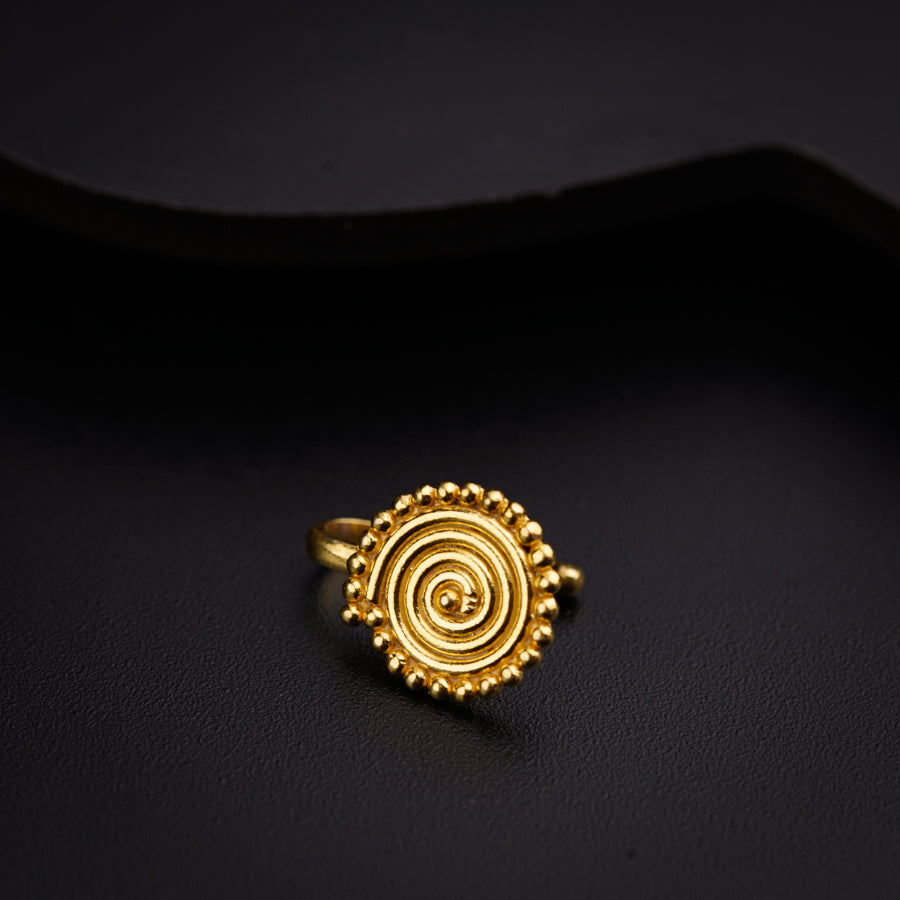 a gold ring sitting on top of a black surface