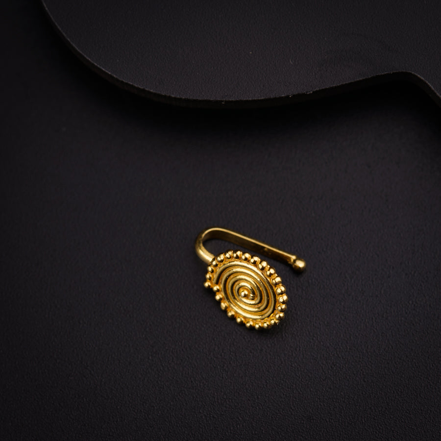 a gold ring sitting on top of a black surface
