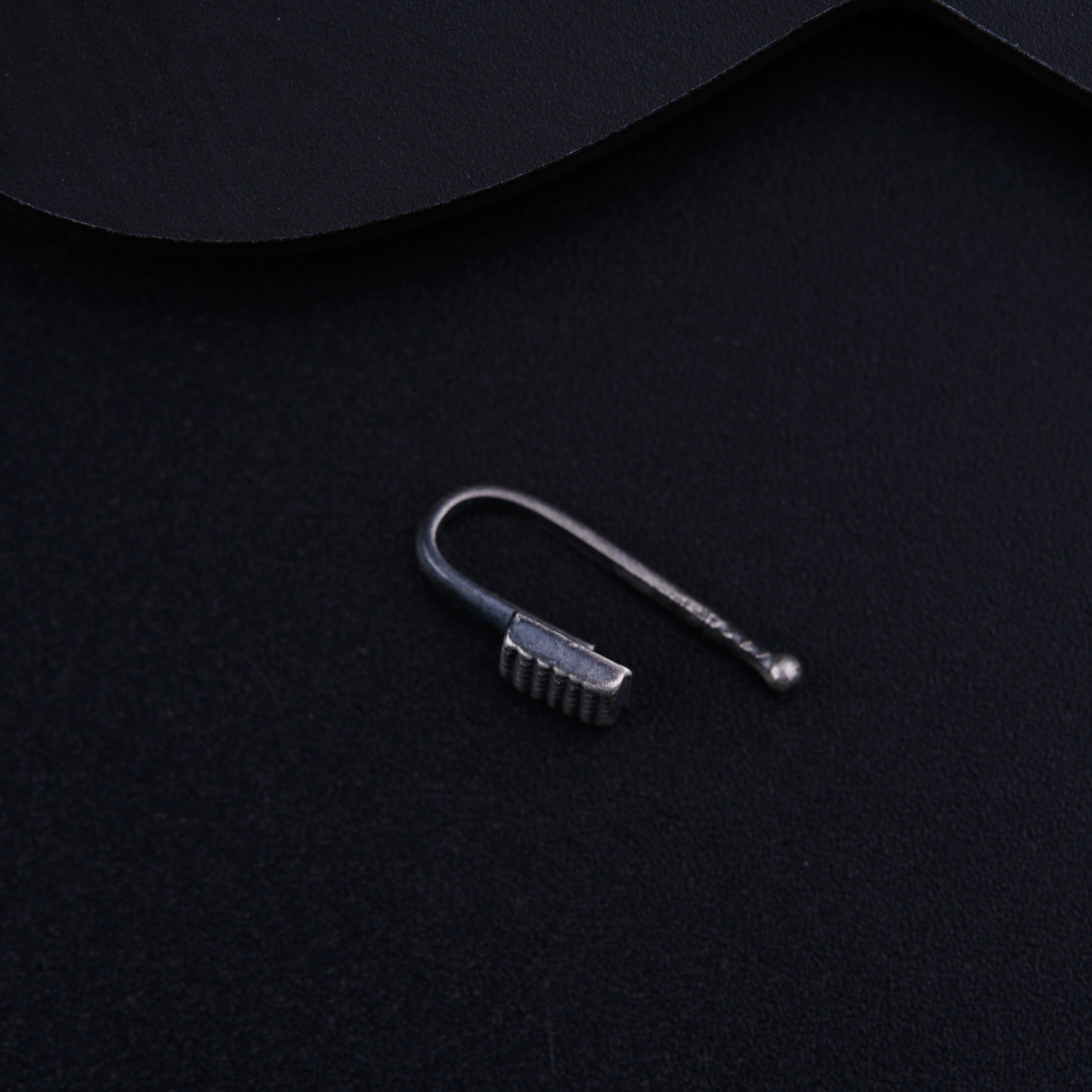 a pair of scissors sitting on top of a black surface