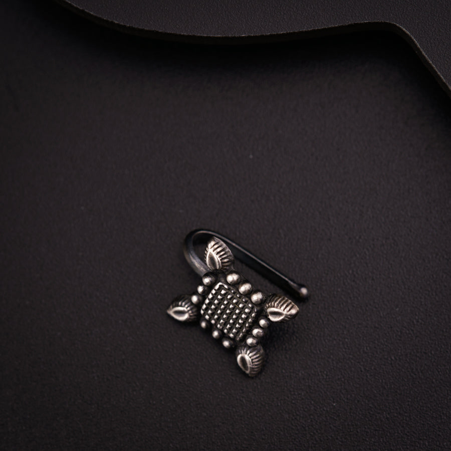 a close up of a metal object on a black surface