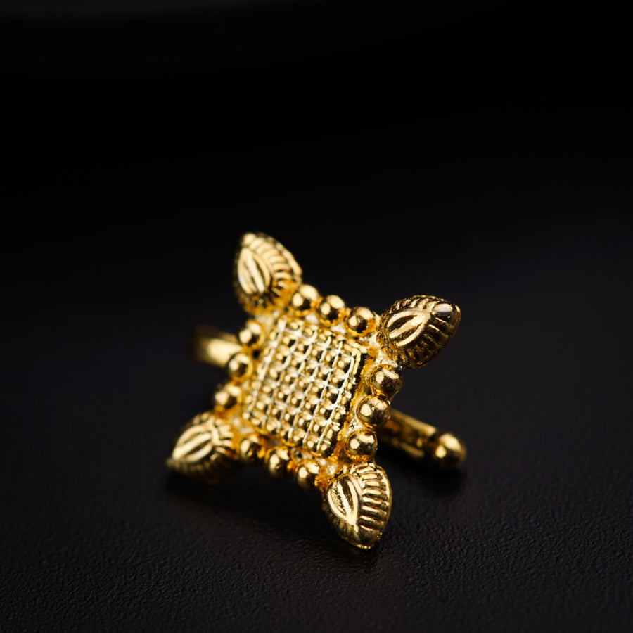a close up of a gold ring on a black surface