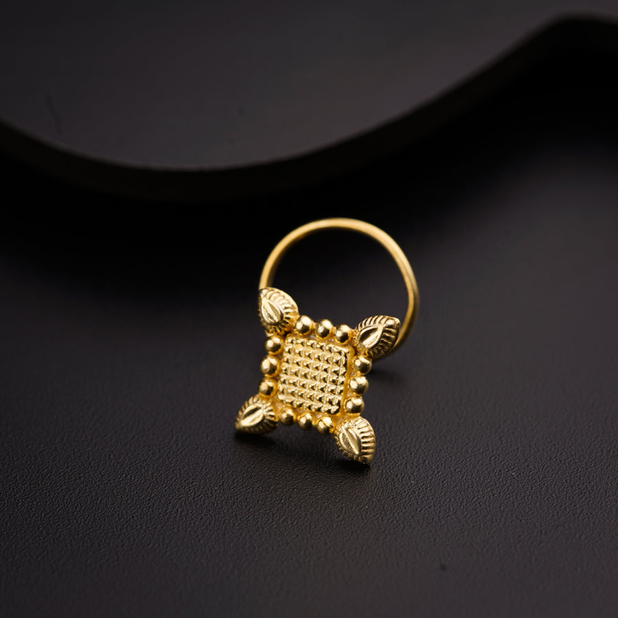 a close up of a gold ring on a black surface