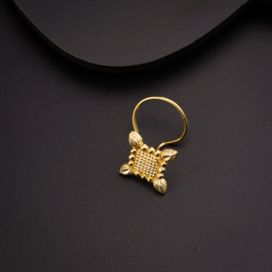 a close up of a gold ring with a turtle on it