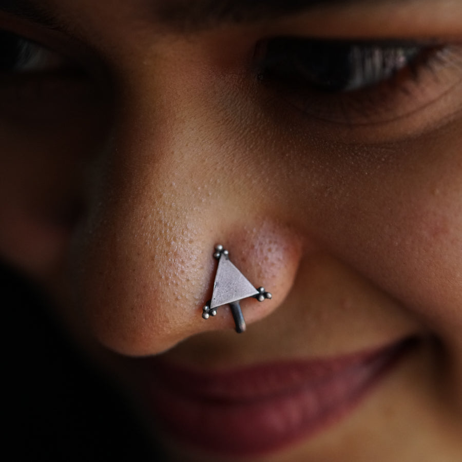 a close up of a person with a nose piercing