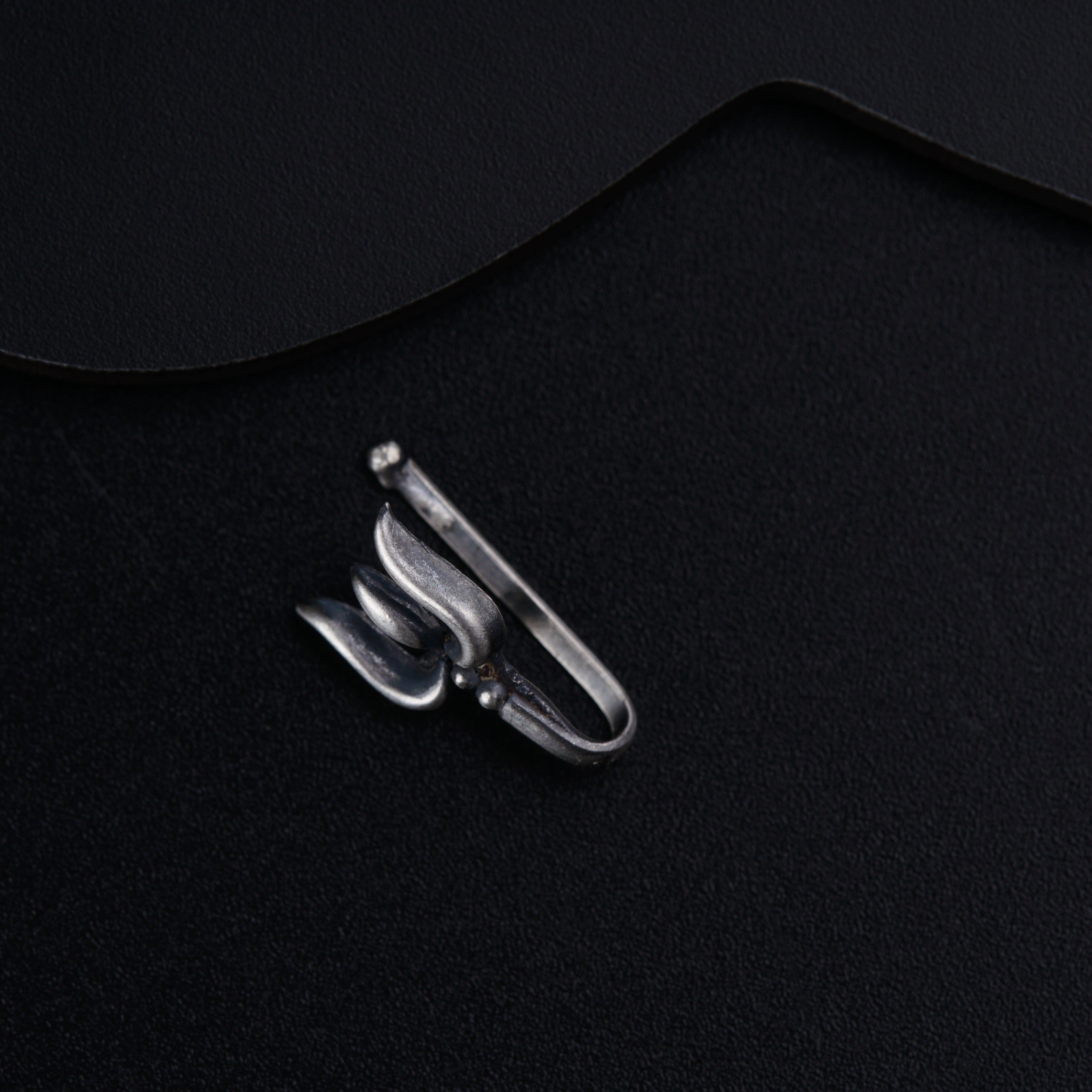 a pair of scissors sitting on top of a black surface