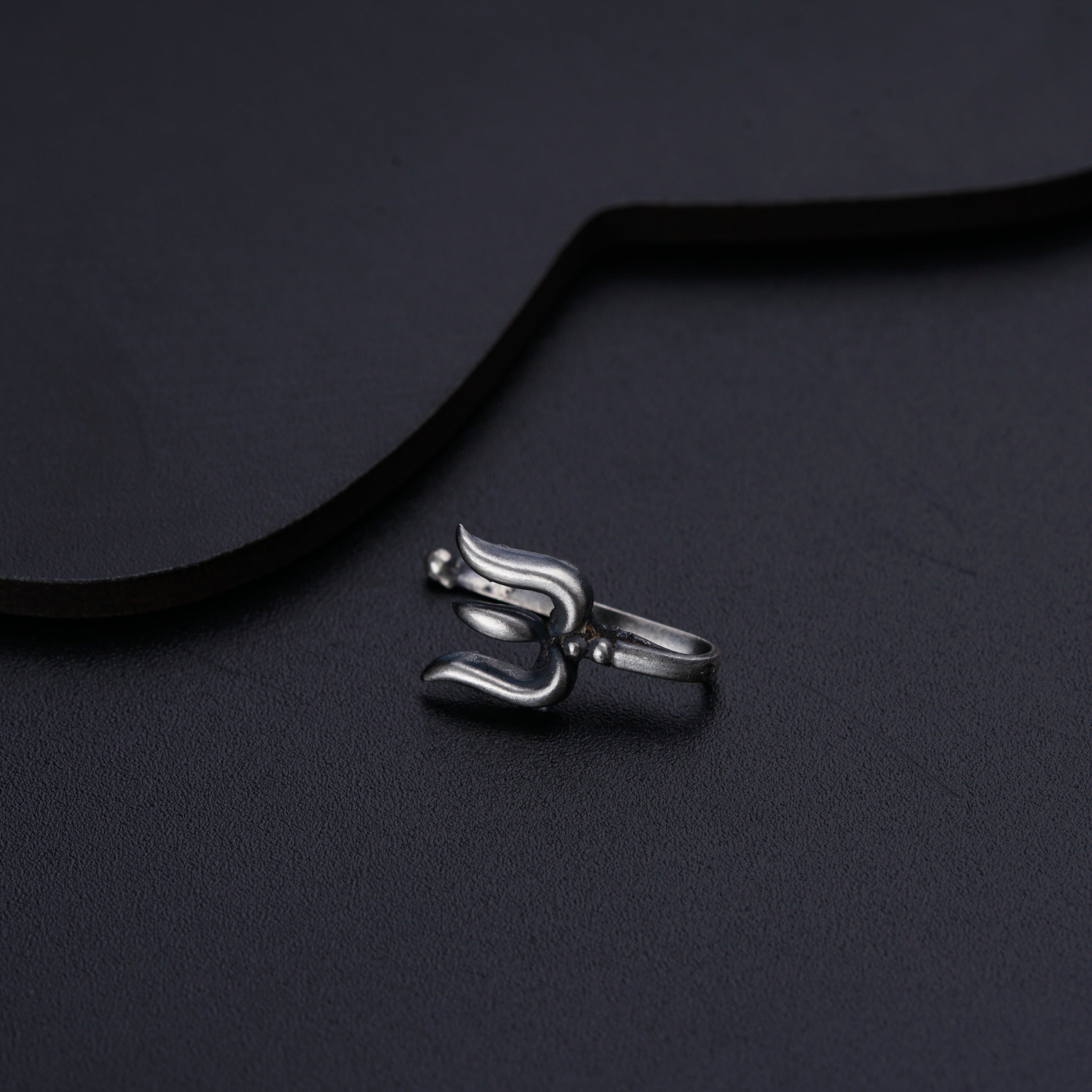 a close up of a metal object on a black surface