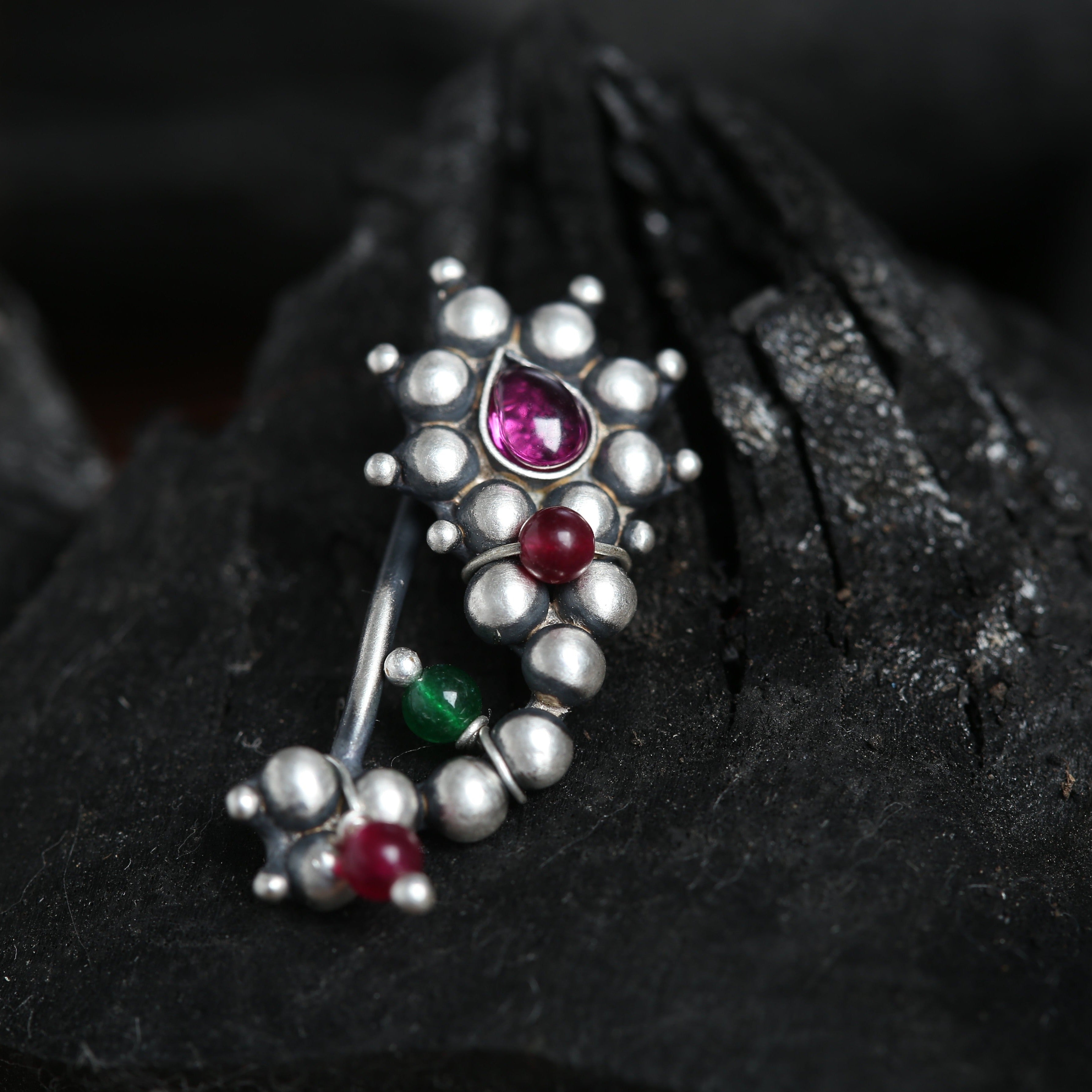 a close up of a brooch on a rock