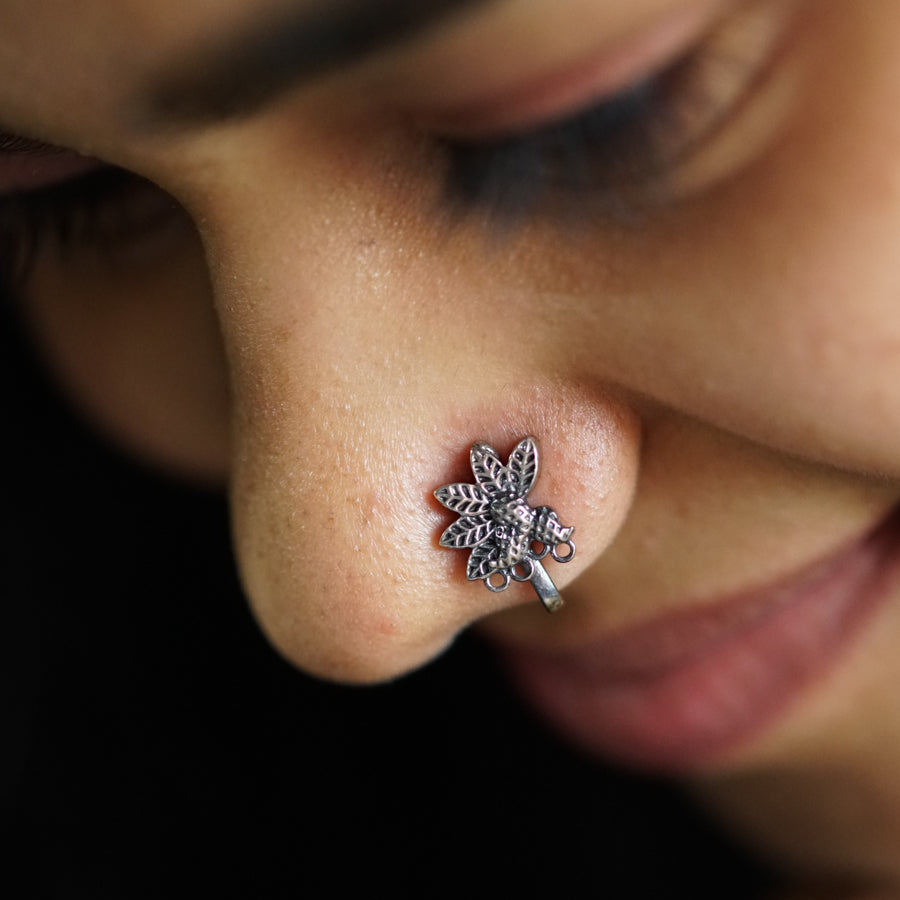 a close up of a person with a nose piercing