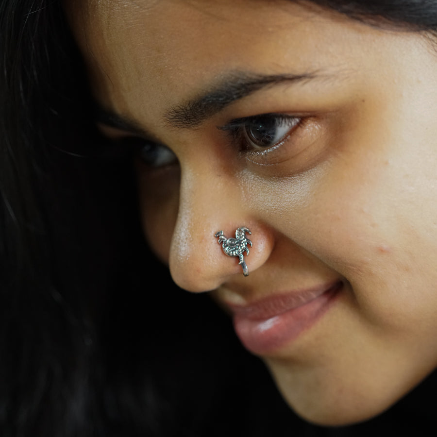 a close up of a person with a nose piercing