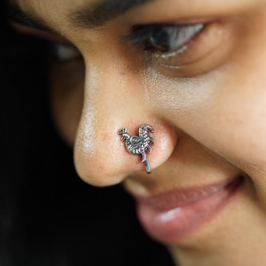 a close up of a person with a nose piercing