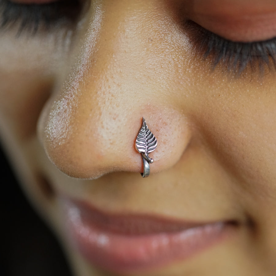 a close up of a person with a nose piercing