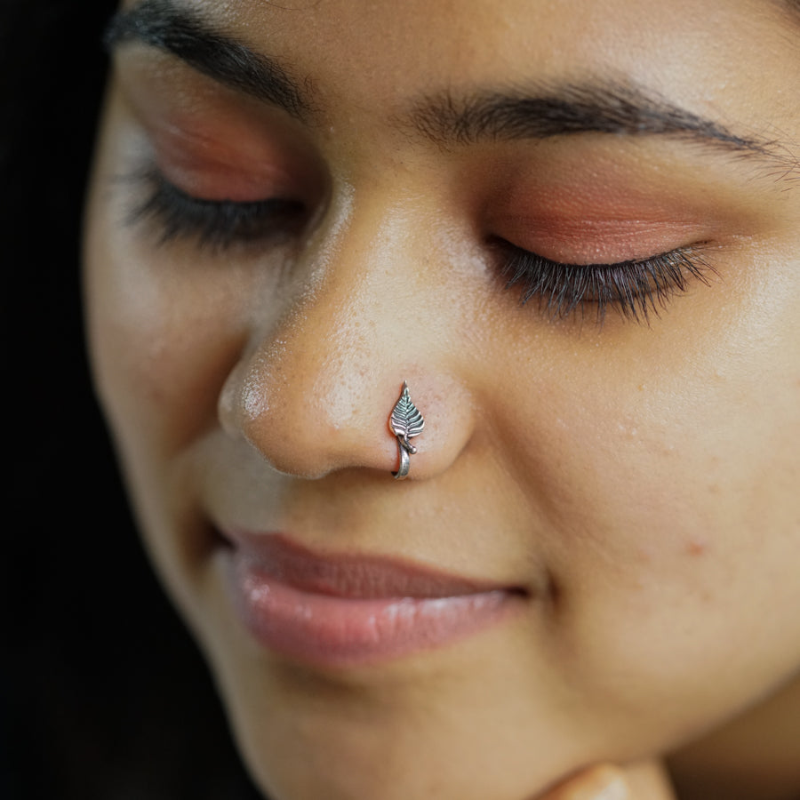 a close up of a person with a nose piercing